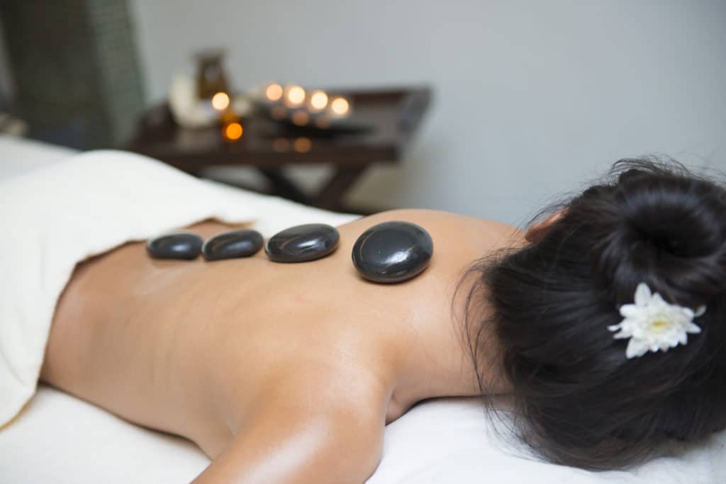 massage with hot black stone by therapists